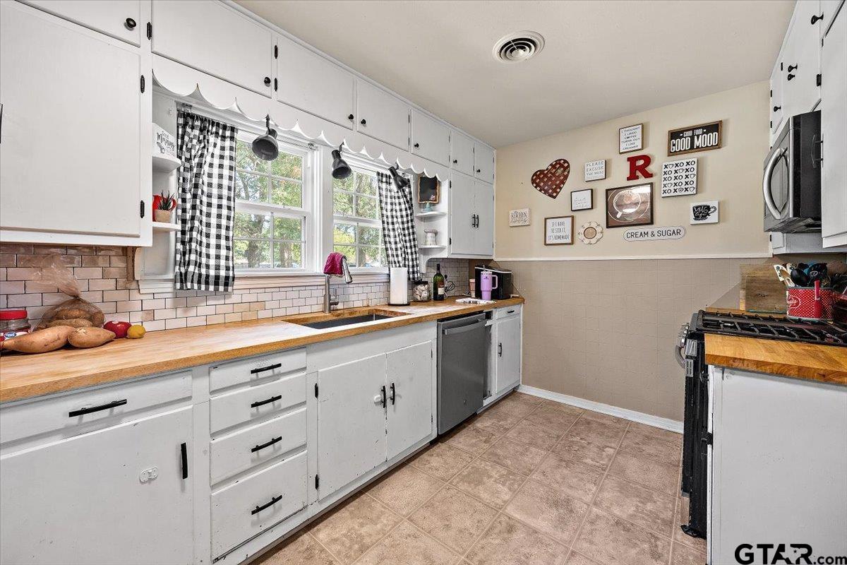 228 Fairview Street Rusk, TX 75785 - Photo 15 of 35 a kitchen with granite countertop a sink and cabinets