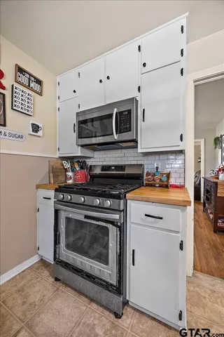 a kitchen with stainless steel appliances granite countertop a stove and a microwave