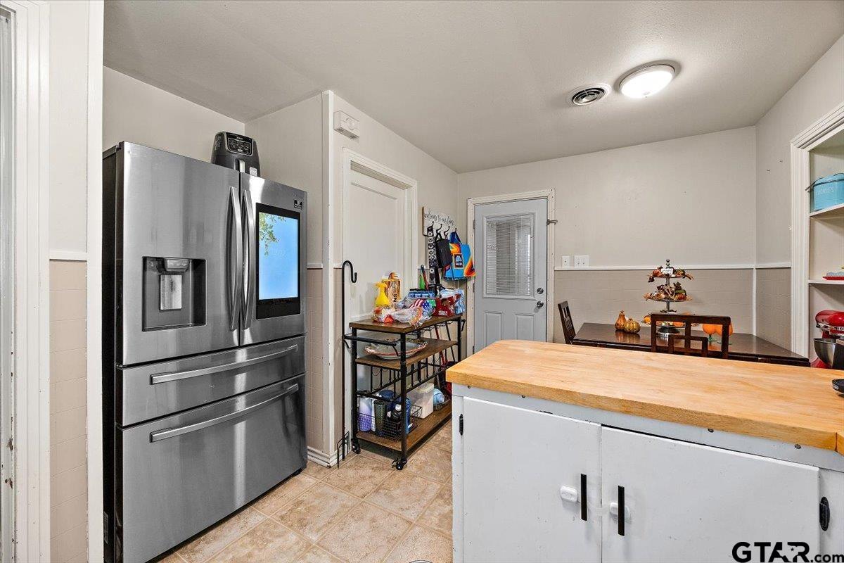 228 Fairview Street Rusk, TX 75785 - Photo 17 of 35 a kitchen with stainless steel appliances kitchen island sink refrigerator and stove