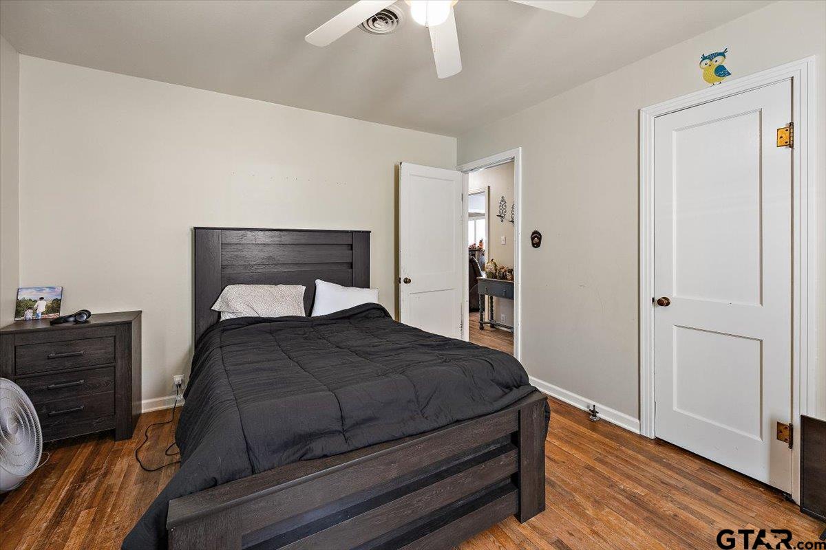 228 Fairview Street Rusk, TX 75785 - Photo 23 of 35 a bedroom with a bed and wooden floor