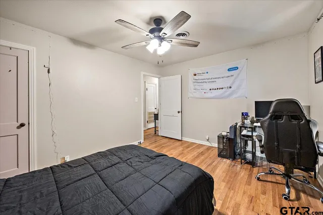 a bedroom with bed and a chandelier