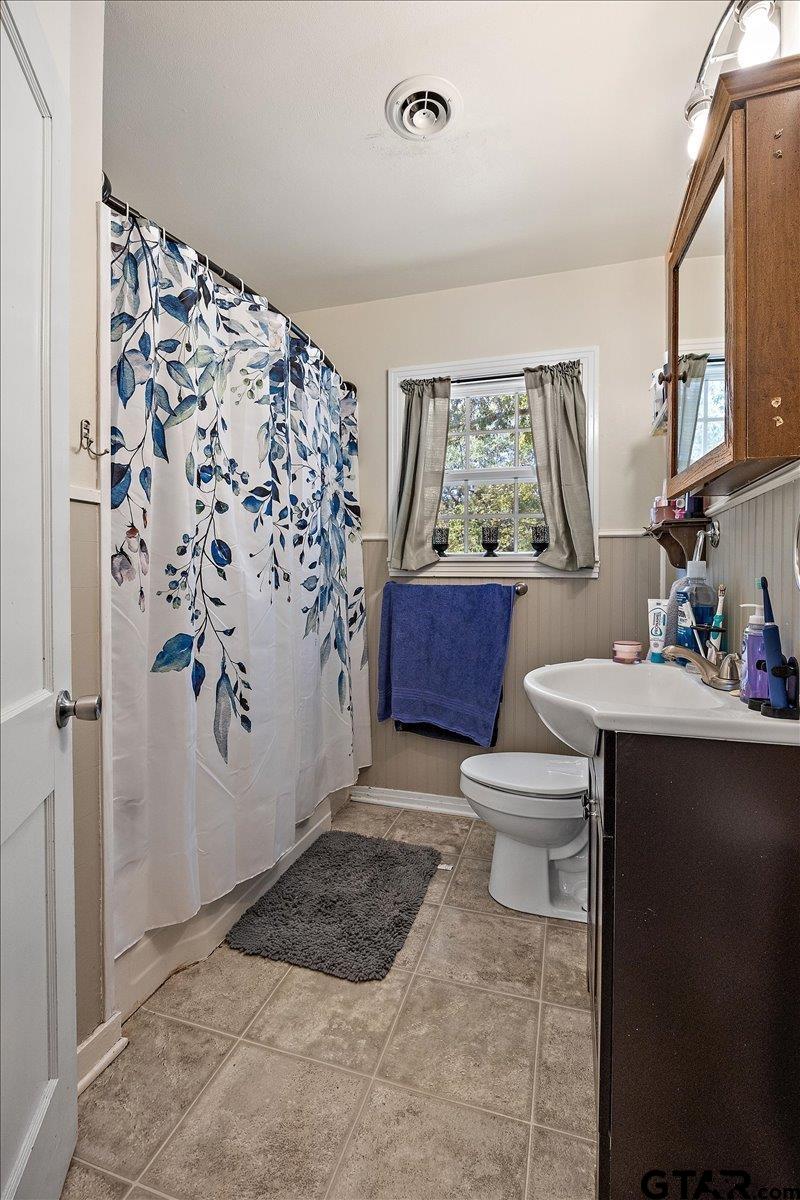 228 Fairview Street Rusk, TX 75785 - Photo 26 of 35 a bathroom with a toilet sink and mirror