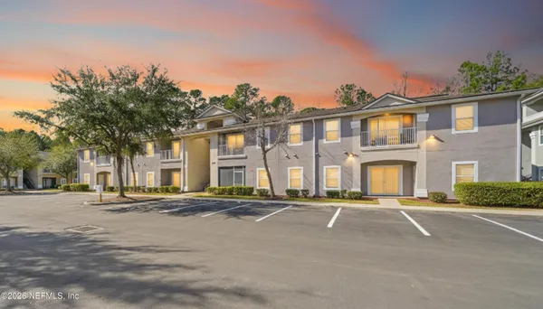 a front view of multiple houses with yard