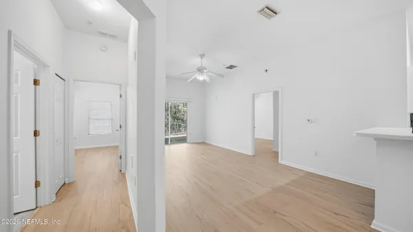a view of a hallway with wooden floor