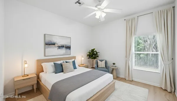 a bedroom with a large bed and a window