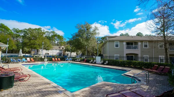 a front view of a house with swimming pool having outdoor seating