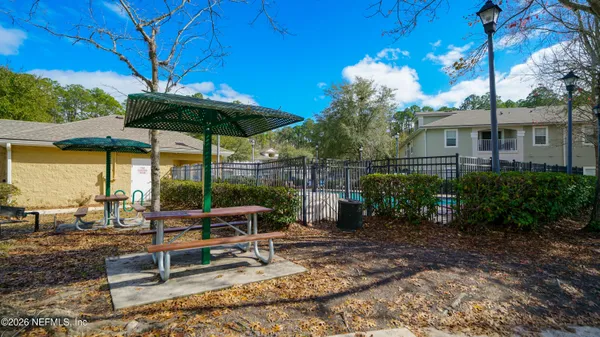 a view of a table and chairs under an umbrella