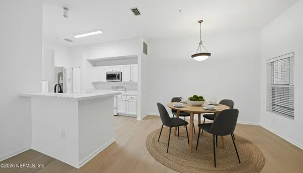 a view of a dining room with furniture and wooden floor