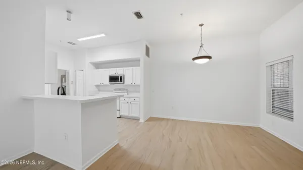 a view of a kitchen with a sink dishwasher stove and cabinets