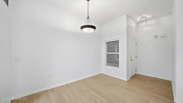 a view of a room with wooden floor and windows