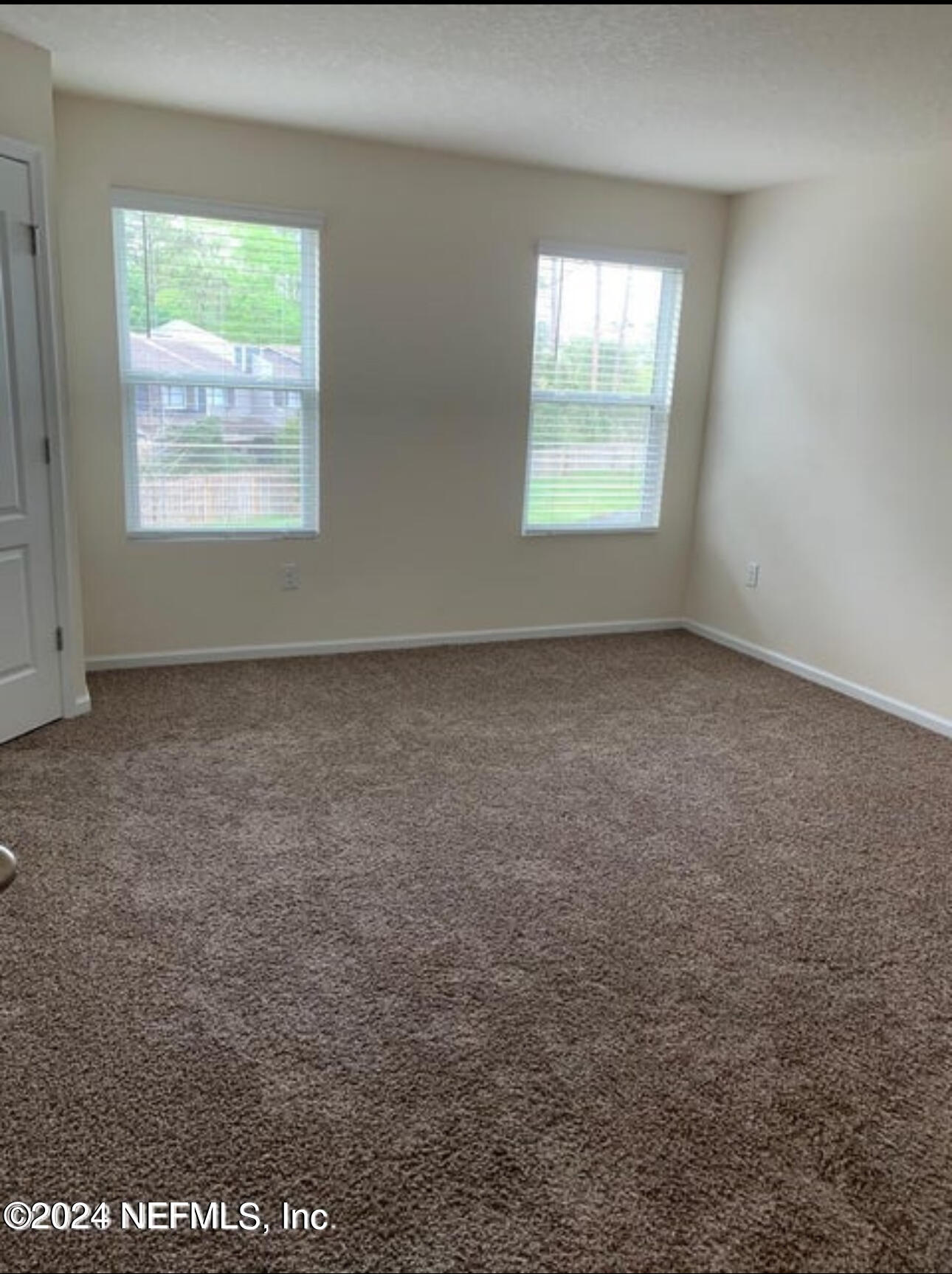 7945 Echo Springs Road Jacksonville, FL 32256 - Photo 5 of 10 an empty room with windows