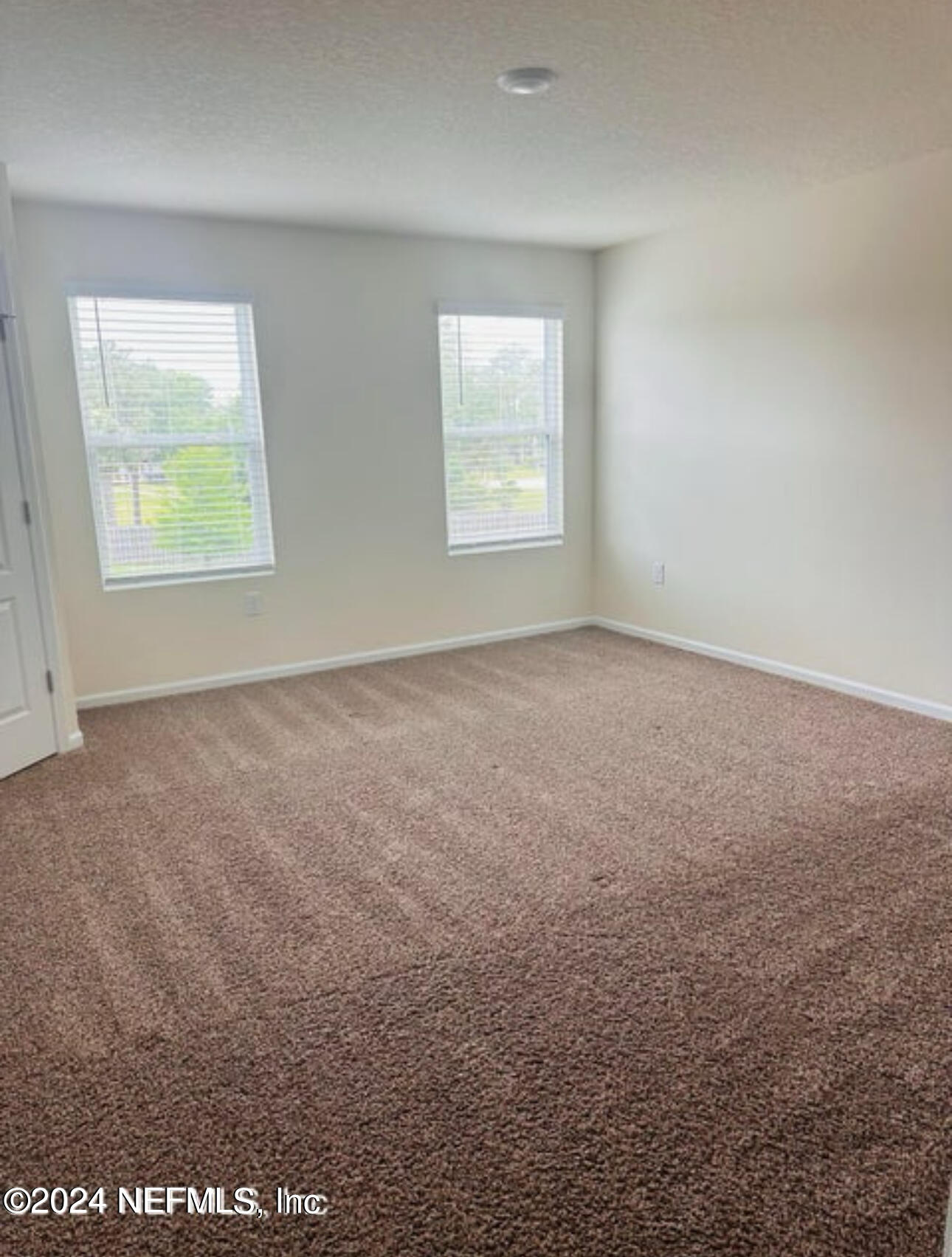 7945 Echo Springs Road Jacksonville, FL 32256 - Photo 6 of 10 an empty room with windows