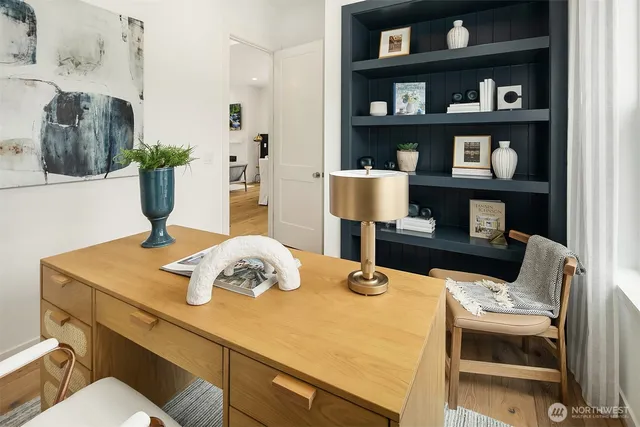 a view of a dining room with furniture and book shelf