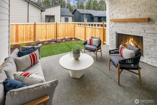 a outdoor space with patio fireplace couches and a fireplace