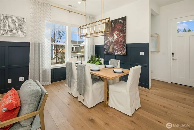 a dining room with furniture a chandelier and wooden floor