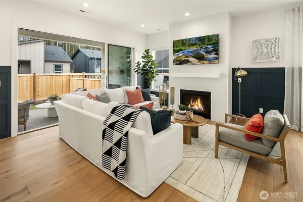 a living room with furniture a flat screen tv and a fireplace