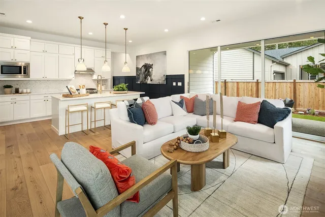 a living room with stainless steel appliances kitchen island granite countertop furniture and a view of kitchen