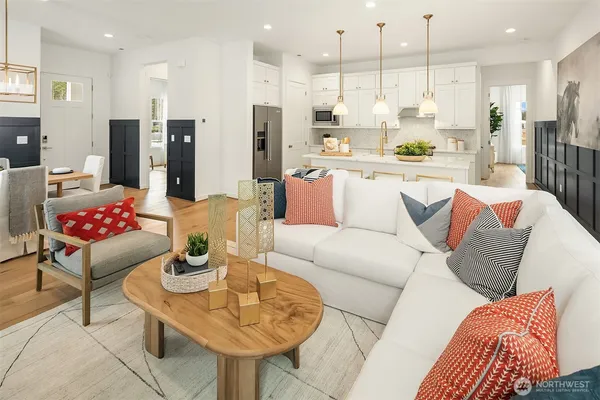 a living room with stainless steel appliances kitchen island granite countertop furniture and a view of kitchen
