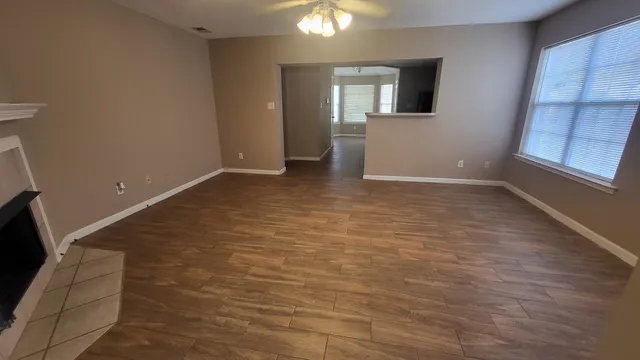 a view of room with window and wooden floor