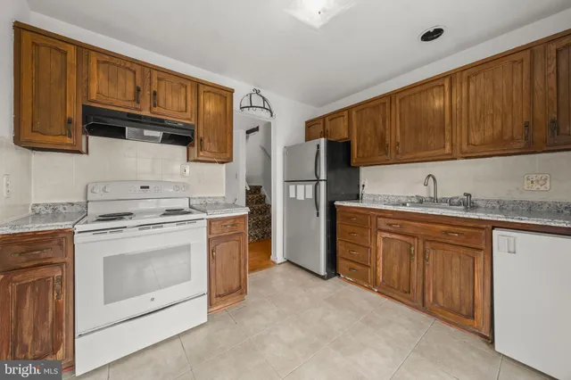 a kitchen with stainless steel appliances granite countertop a stove sink microwave and refrigerator