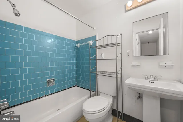 a bathroom with a sink mirror toilet and bathtub