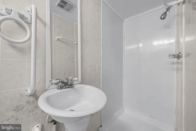 a bathroom with a sink a toilet and a mirror