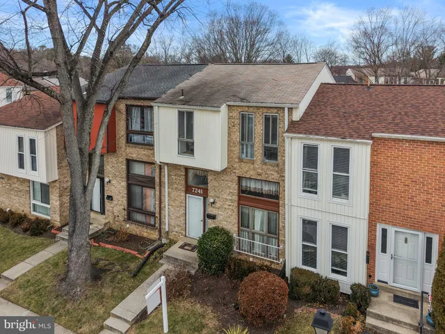 a front view of a house with garden and plants
