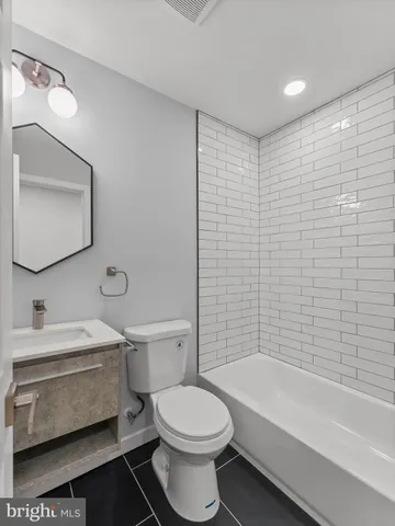 a bathroom with a toilet a sink and bathtub