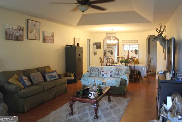 a living room with furniture and a chandelier