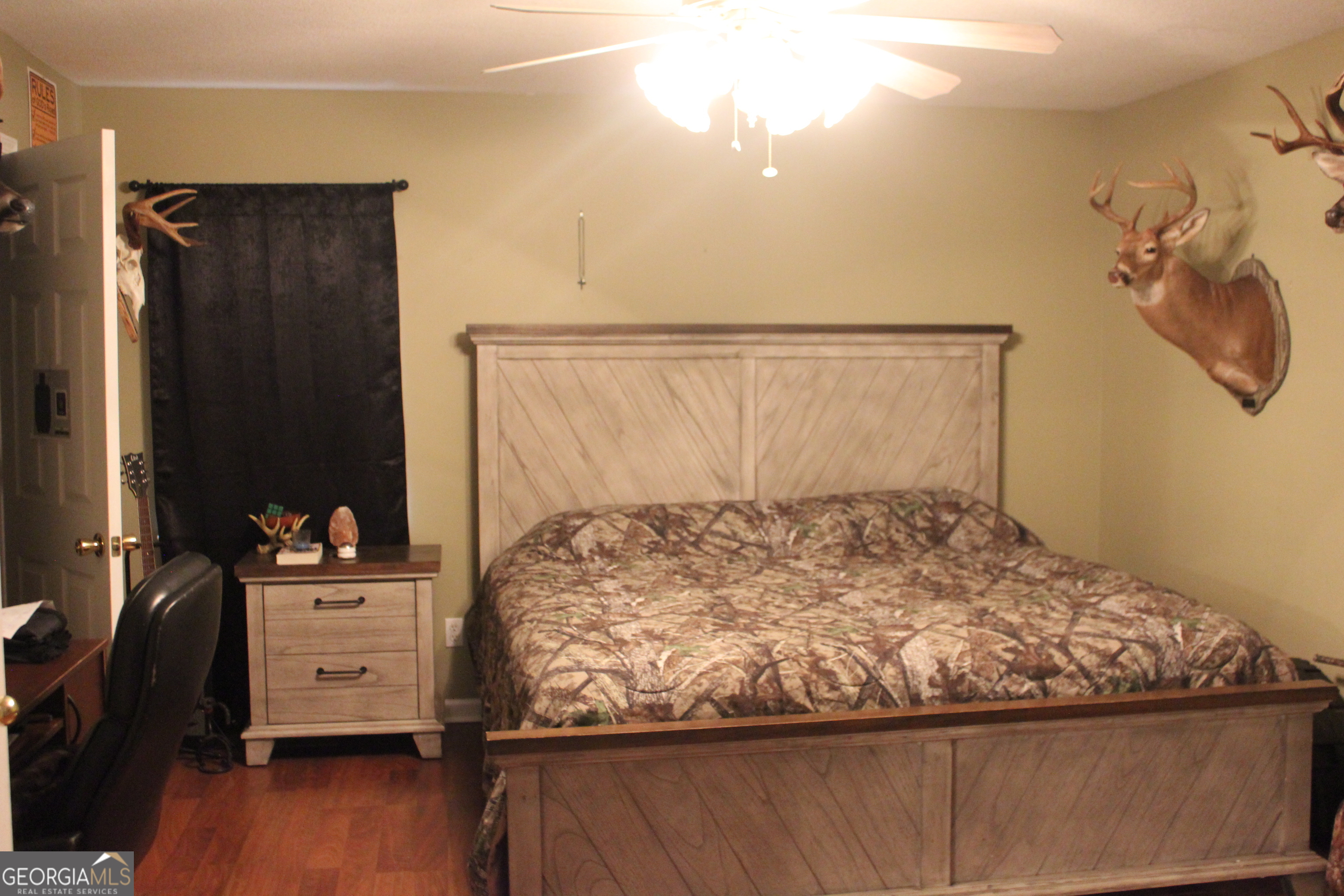 2850 Isaac Akins Road Statesboro, GA 30458 - Photo 18 of 29 a bedroom with a bed and wooden floor