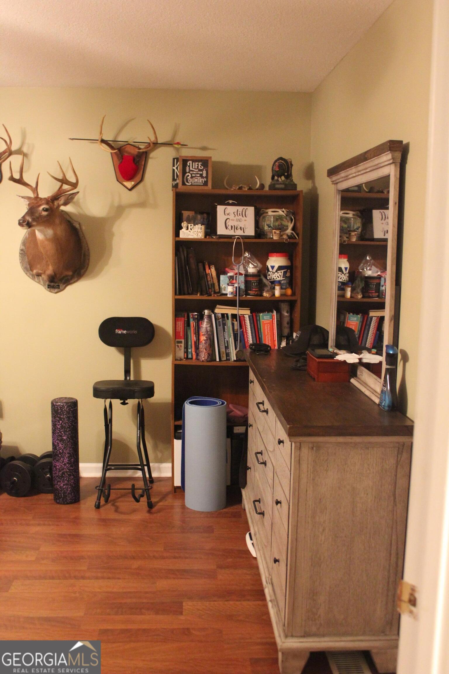 2850 Isaac Akins Road Statesboro, GA 30458 - Photo 19 of 29 a view of a workspace with furniture and wooden floor