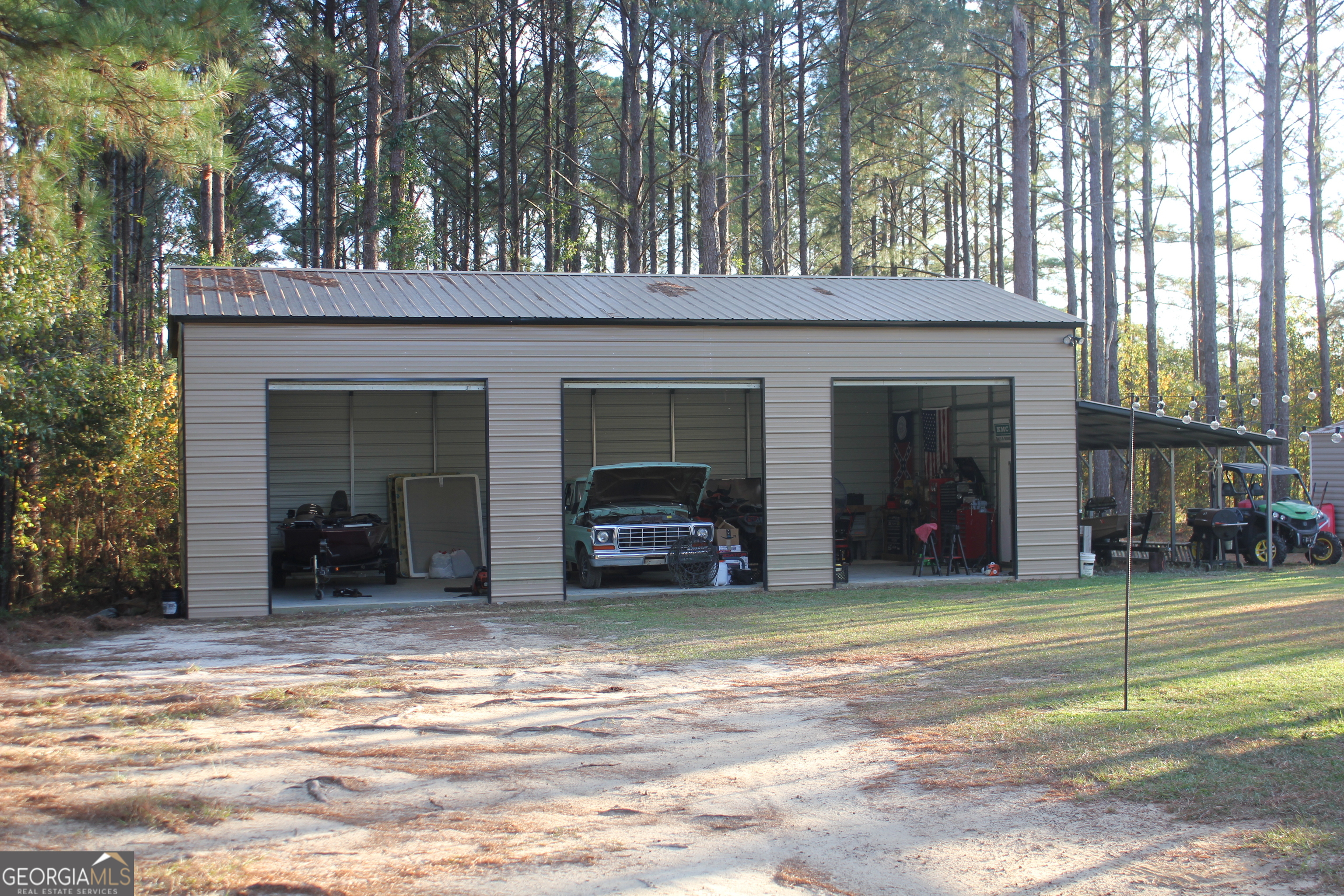 2850 Isaac Akins Road Statesboro, GA 30458 - Photo 27 of 29 a view of a house with a yard and garage