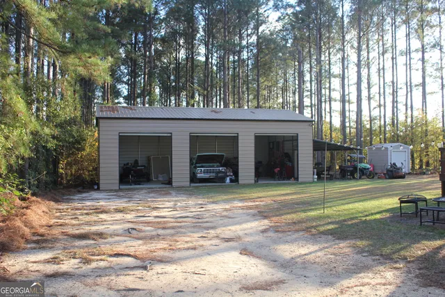 a view of a house with a yard and sitting area