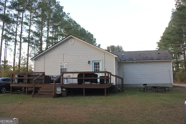 a view of a house with a yard and sitting area