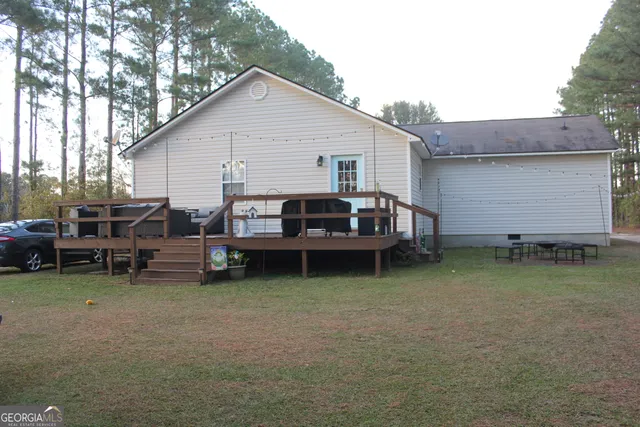 a view of a house with a yard and sitting area