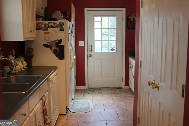a view of a kitchen with a sink and cabinets