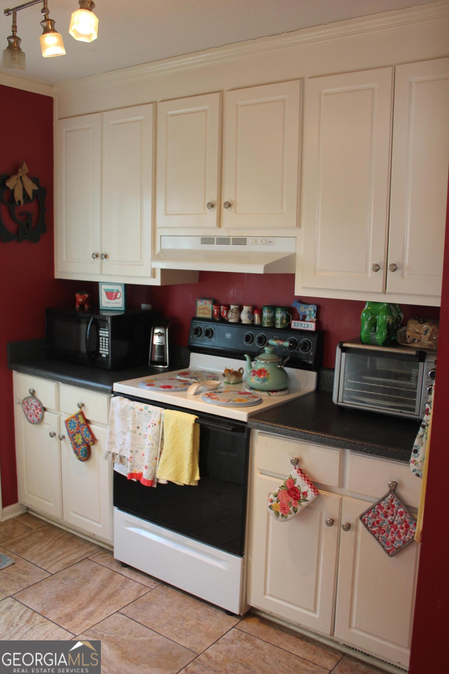 2850 Isaac Akins Road Statesboro, GA 30458 - Photo 9 of 29 a kitchen with stainless steel appliances granite countertop a stove and cabinets