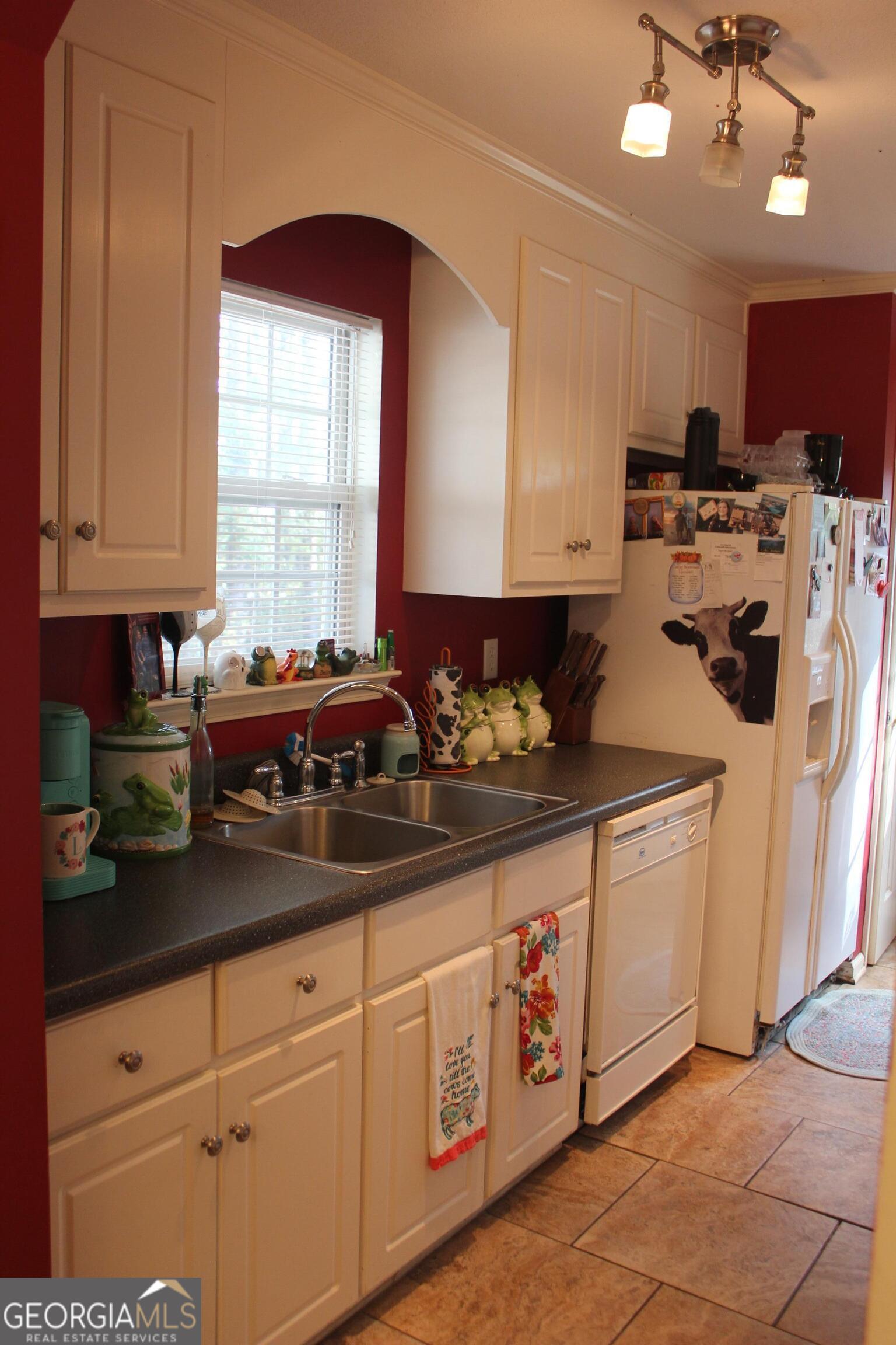 2850 Isaac Akins Road Statesboro, GA 30458 - Photo 10 of 29 a kitchen with stainless steel appliances granite countertop a sink a stove and cabinets