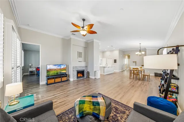 a living room with furniture and a flat screen tv with kitchen view