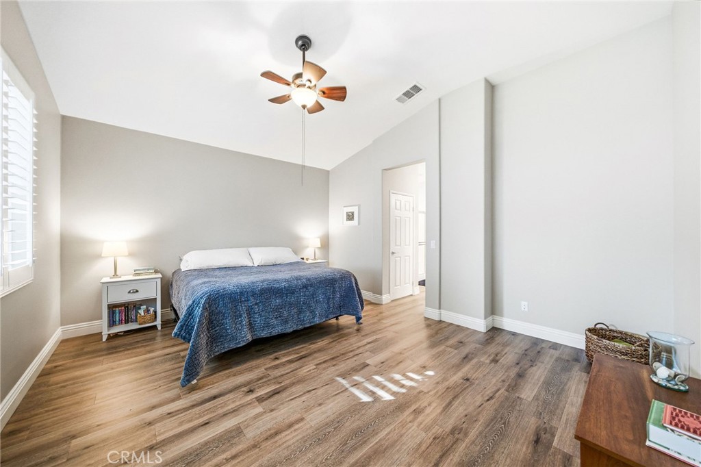 26535 Rim Creek Path, Unit PATHWAY Menifee, CA 92584 - Photo 22 of 50 a bedroom with a bed and wooden floor