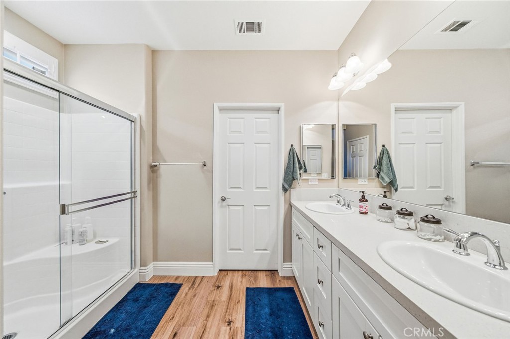 26535 Rim Creek Path, Unit PATHWAY Menifee, CA 92584 - Photo 24 of 50 a bathroom with a double vanity sink and mirror