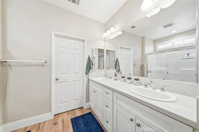 a bathroom with a double vanity sink mirror and