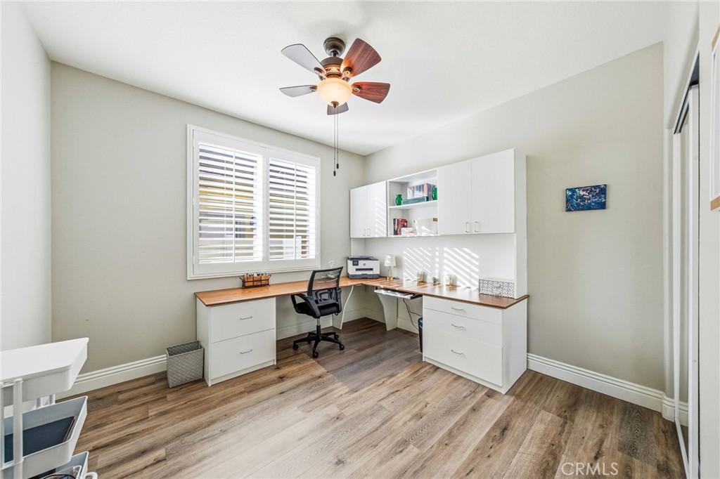 26535 Rim Creek Path, Unit PATHWAY Menifee, CA 92584 - Photo 28 of 50 a kitchen with a stove a sink and cabinets