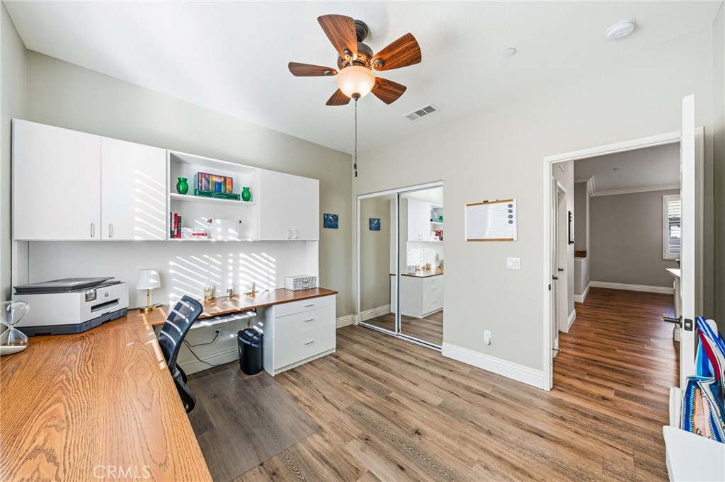 26535 Rim Creek Path, Unit PATHWAY Menifee, CA 92584 - Photo 29 of 50 a living room with stainless steel appliances furniture and a wooden floor