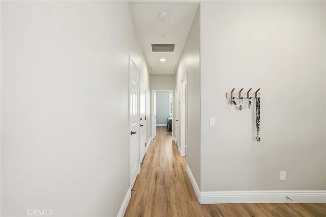a view of a hallway with wooden floor