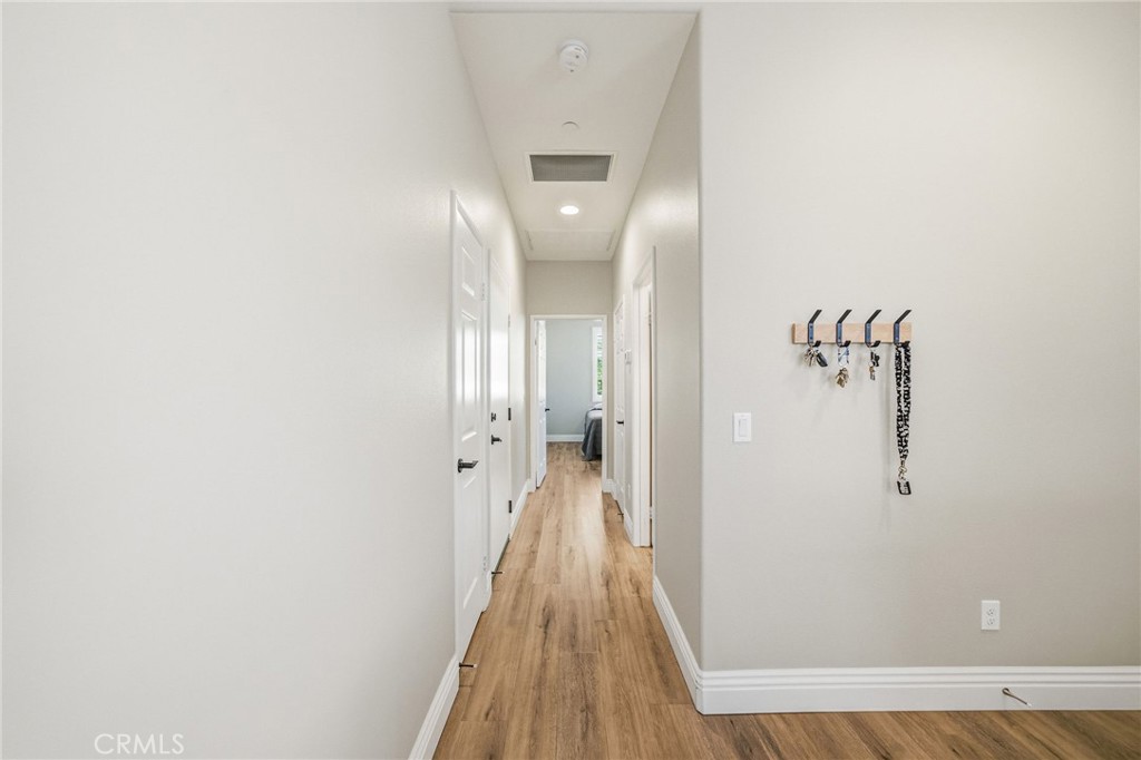 26535 Rim Creek Path, Unit PATHWAY Menifee, CA 92584 - Photo 31 of 50 a view of a hallway with wooden floor