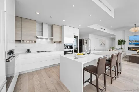 a large kitchen with stainless steel appliances and a refrigerator