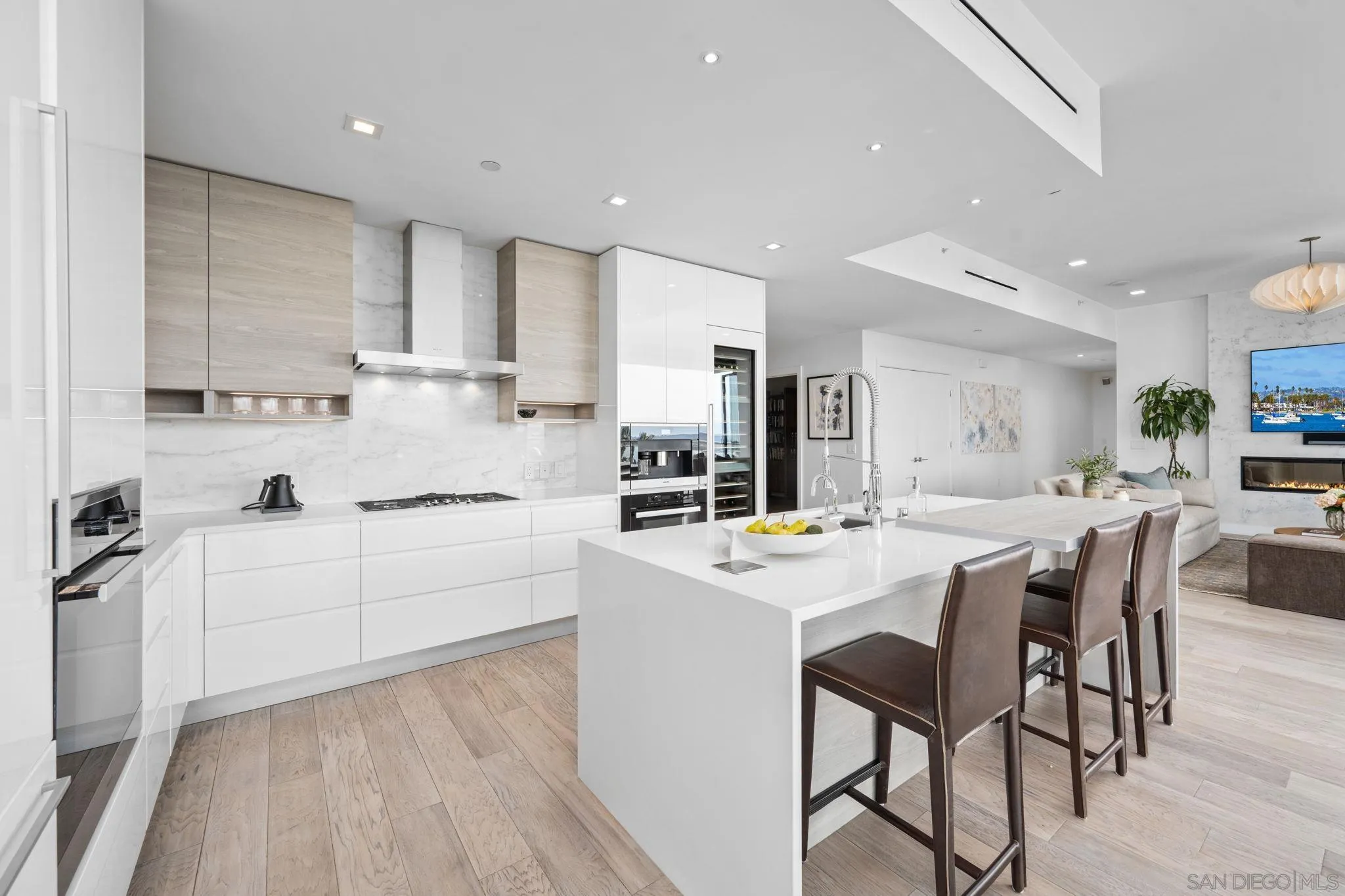 2604 Fifth Avenue, Unit 804 San Diego, CA 92103 - Photo 13 of 72 a kitchen with white cabinets appliances and chairs