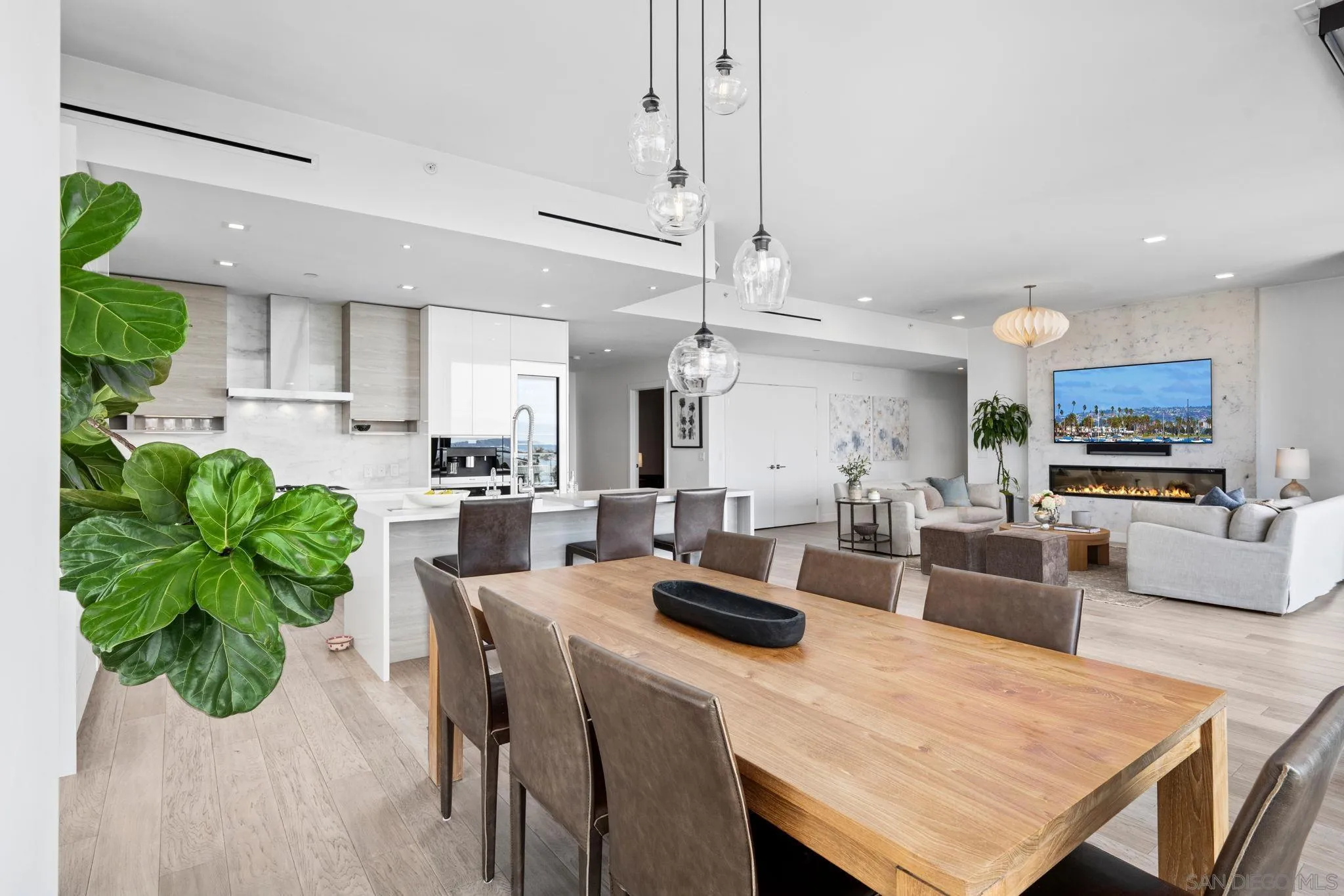 2604 Fifth Avenue, Unit 804 San Diego, CA 92103 - Photo 23 of 72 a kitchen with stainless steel appliances kitchen island granite countertop a stove a refrigerator a sink a dining table and chairs with wooden floor