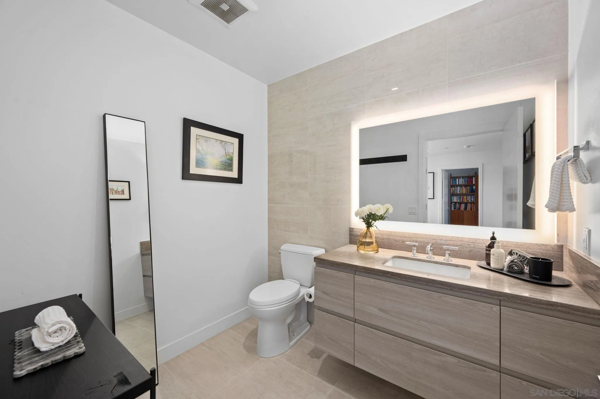 2604 Fifth Avenue, Unit 804 San Diego, CA 92103 - Photo 28 of 72 a bathroom with a toilet sink and mirror